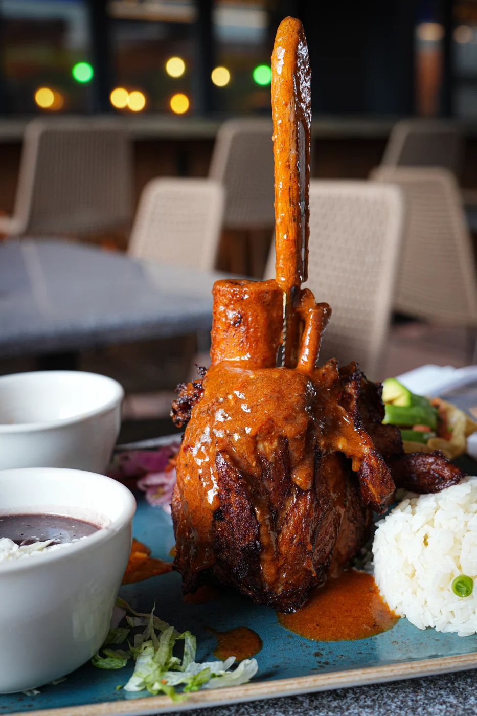 A plated tomahawk steak photographed by EL RITUAL